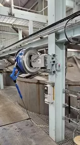 High-pressure stainless steel hose reel and trigger gun mounted to a support column as part of the washdown system at an industrial site in Burton with lance and gun